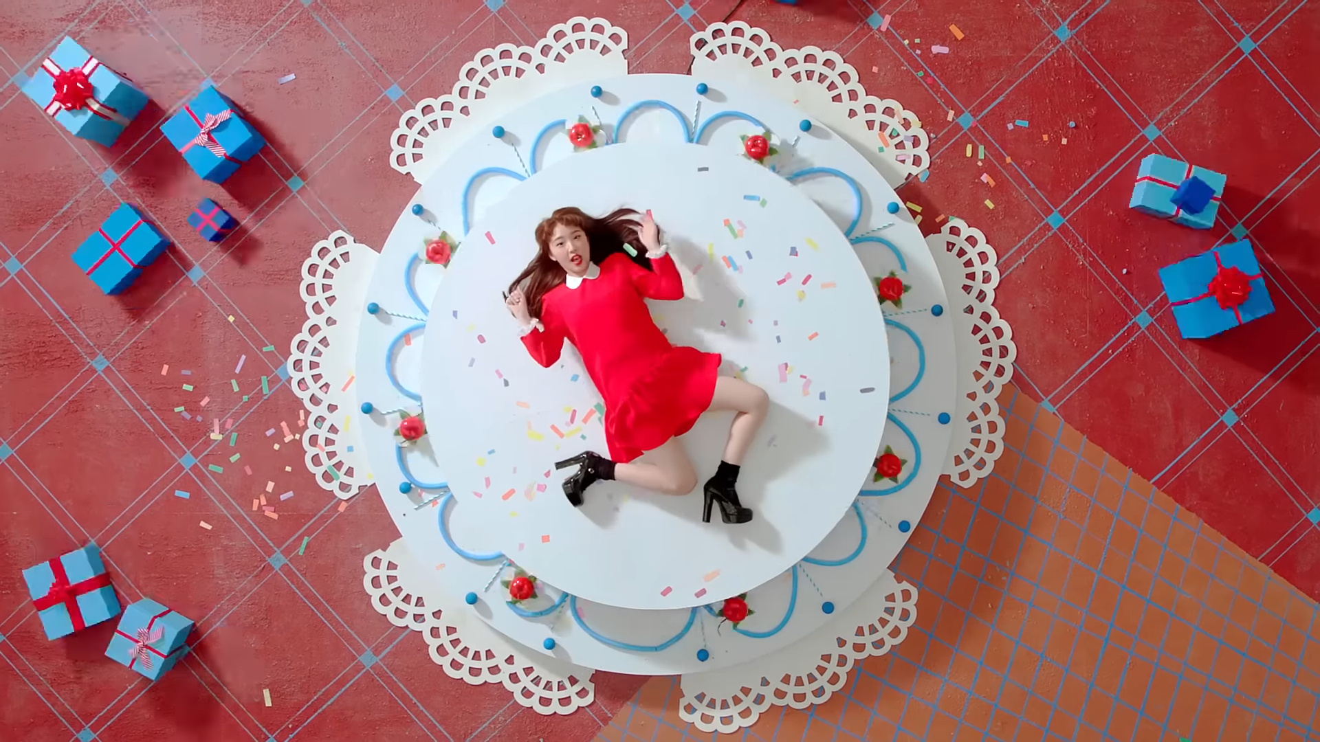 Yeojin laying on a giant cake.